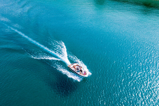 An aerial view of a group of friends power boating on Lake Tahoe, CA