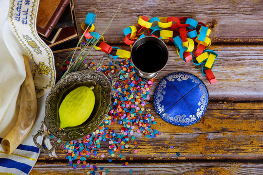 Jewish ritual festival of Sukkot in the jewish religious symbol over paper colorful chain garland praying book kippah tallit