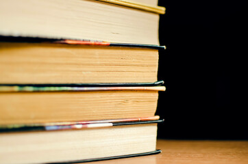 Collection of old books on dark background.