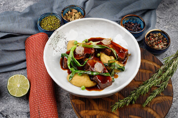 pork in sauce with potatoes,onions, green peas