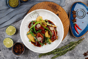pork in sauce with potatoes,onions, green peas