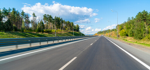 the road surface of the route, the empty asphalt road highway blue sky and autumn forest