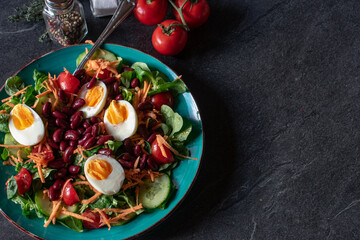 Background image with a healthy salad on dark background with copy space