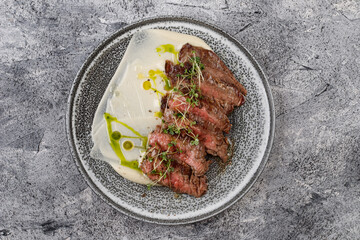 Grilled beef steak with herbs and sauce.