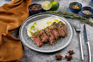 Grilled beef steak with herbs and sauce.