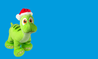 Soft toy dragon isolated on blue background. Kids toys