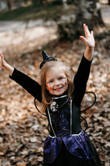 Little girl dressed up as a witch isolated on white