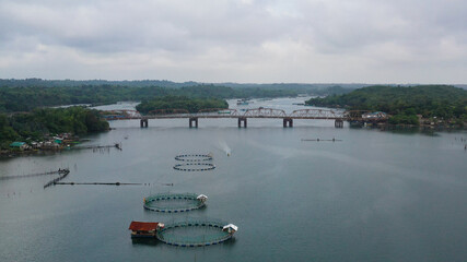 Obraz premium Aerial view of fish ponds for bangus, milkfish. Fish farm, top view. large scale traditional floating fish farms.