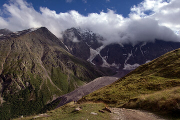 Mountain peaks with glaciers.
View of Mount Donguzorun from the slopes of Mount Cheget. Terskol, Caucasus, Russia.