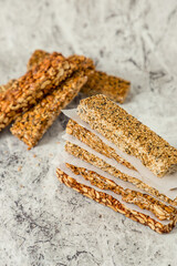 Super food breakfast Granola bars with Oats, Almonds, Pumpkin seeds, Flax seeds, Honey and Dates. flat lay on textured background with ingredients. with copy space.