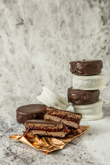 Homemade chocolate alfajores, typical of Argentina, marble background with copy space