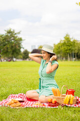 Beautiful young woman having picnic.