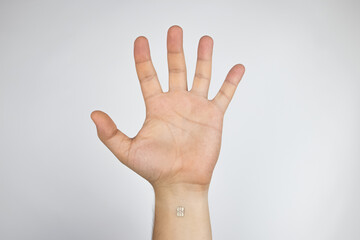 The man shows his hand with a chip implanted. The concept of chipping and implantation of...