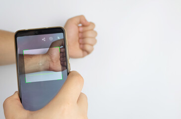 A man reads data using a special device from an implanted chip in a man's hand. Future technology concept and human chipping. Electronic documents and biotechnology