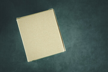 Brown cardboard box on a black background. Top view