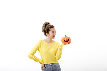 Young woman holding a pumpkin in halloween on white