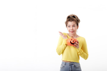 Young woman holding a pumpkin in halloween on white