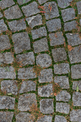 Abstract background of an old cobblestone street close-up.