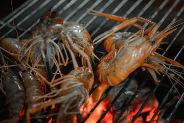 Grilled shrimps or prawns on the flaming grill