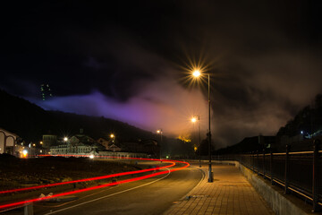 Fototapeta na wymiar Purple clouds of the night city in Krasnaya Polyana Sochi.