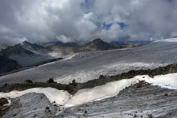 Climbing Elbrus. View from the slopes of Elbrus.
A view from the slopes of Elbrus to the surrounding mountain peaks covered with snow.