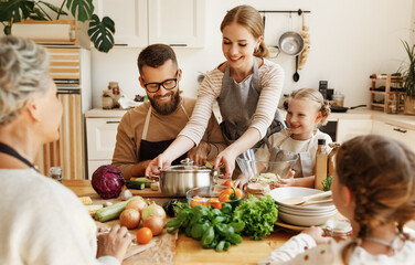Happy family preparing healthy lunch together.