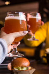 Boy and girl clink glasses of beer