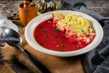 Red borscht soup in bowl.