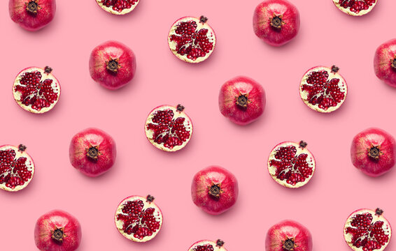 Pattern of fresh pomegranates on pink background