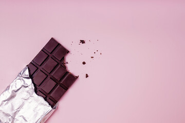 Bited bar of chocolate with crumbs