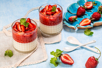 Traditional Italian dessert panna cotta with strawberry jelly. Summer yogurt dessert. Food recipe background. Close up