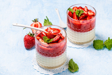 Traditional Italian dessert panna cotta with strawberry jelly. Summer yogurt dessert. Food recipe background. Close up