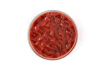 Spicy chili sauce in bowl isolated on white background. Top view
