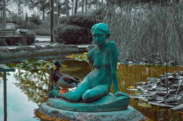 Duck posing with a statue on Margaret Island, Budapest