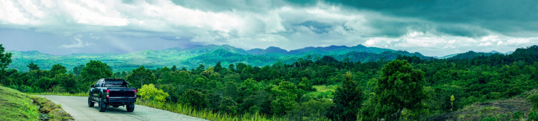 Fototapeta na wymiar Panorama view of travelling on green mountain road with raining, Holiday activity, Beautiful landscape mountain in Thailand