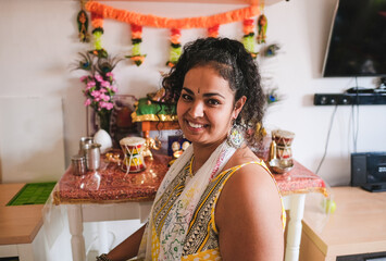 Beautiful indian woman wearing traditional dress while celebrate hindu event at home