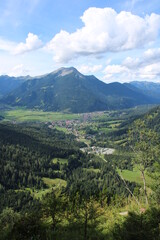 Naklejka na ściany i meble Aerial image of the city of Garmisch-Partenkirchen taken on Kramer Mountain in COVID-19 summer 2020