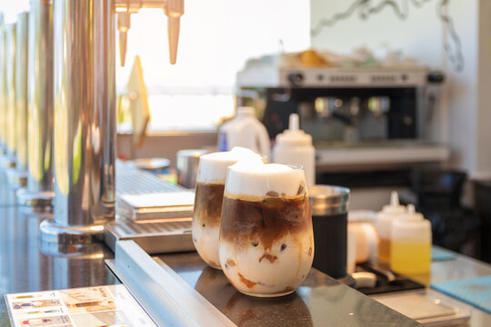 Iced coffee on counter bar with coffee tap.