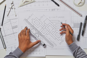 Architect engineer contractor design working drawing sketch plan blueprint and making architectural construction house building in architect studio.