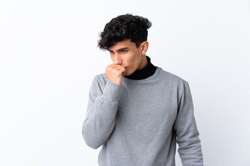 Young Argentinian man over isolated white background having doubts