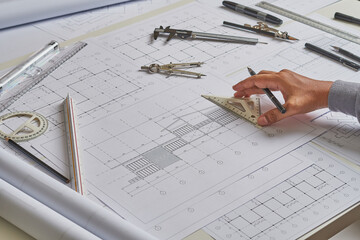 Architect engineer contractor design working drawing sketch plan blueprint and making architectural construction house building in architect studio.