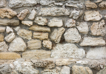 Stones in the wall of the house as an abstract background.
