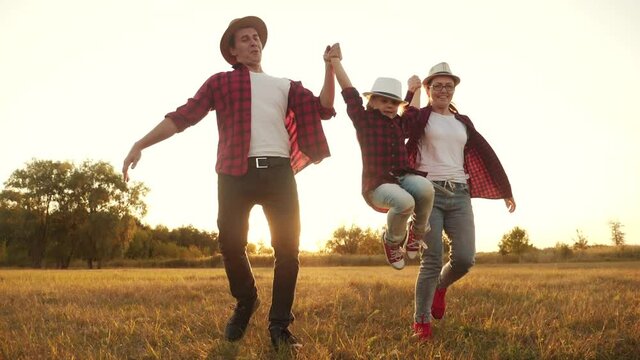 happy family children kid run in the park at sunset. people in the park concept mom dad daughter and son joyful run. happy family and little baby fun a child summer kid dream silhouette concept