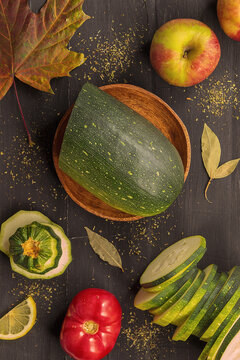 Fresh and healthy vegetables and fruits lie on a black wooden background
