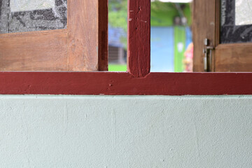 The red window on the cement wall