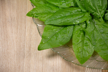 Fresh spinach leaves on wooden background