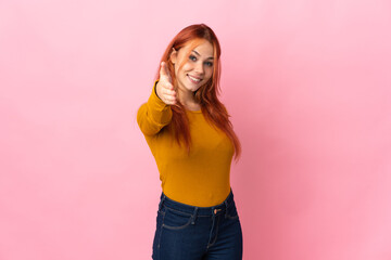 Teenager Russian girl isolated on pink background shaking hands for closing a good deal