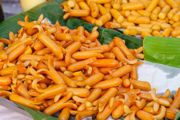 Pork sausages grilling on a portable BBQ