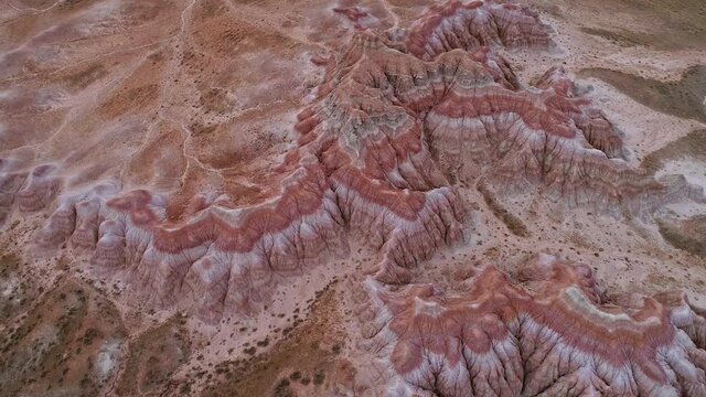 Circling over patterns of the Red Hills from aerial view in Wyoming rising high over the desert.