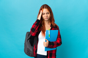 Teenager student Russian girl isolated on blue background with headache
